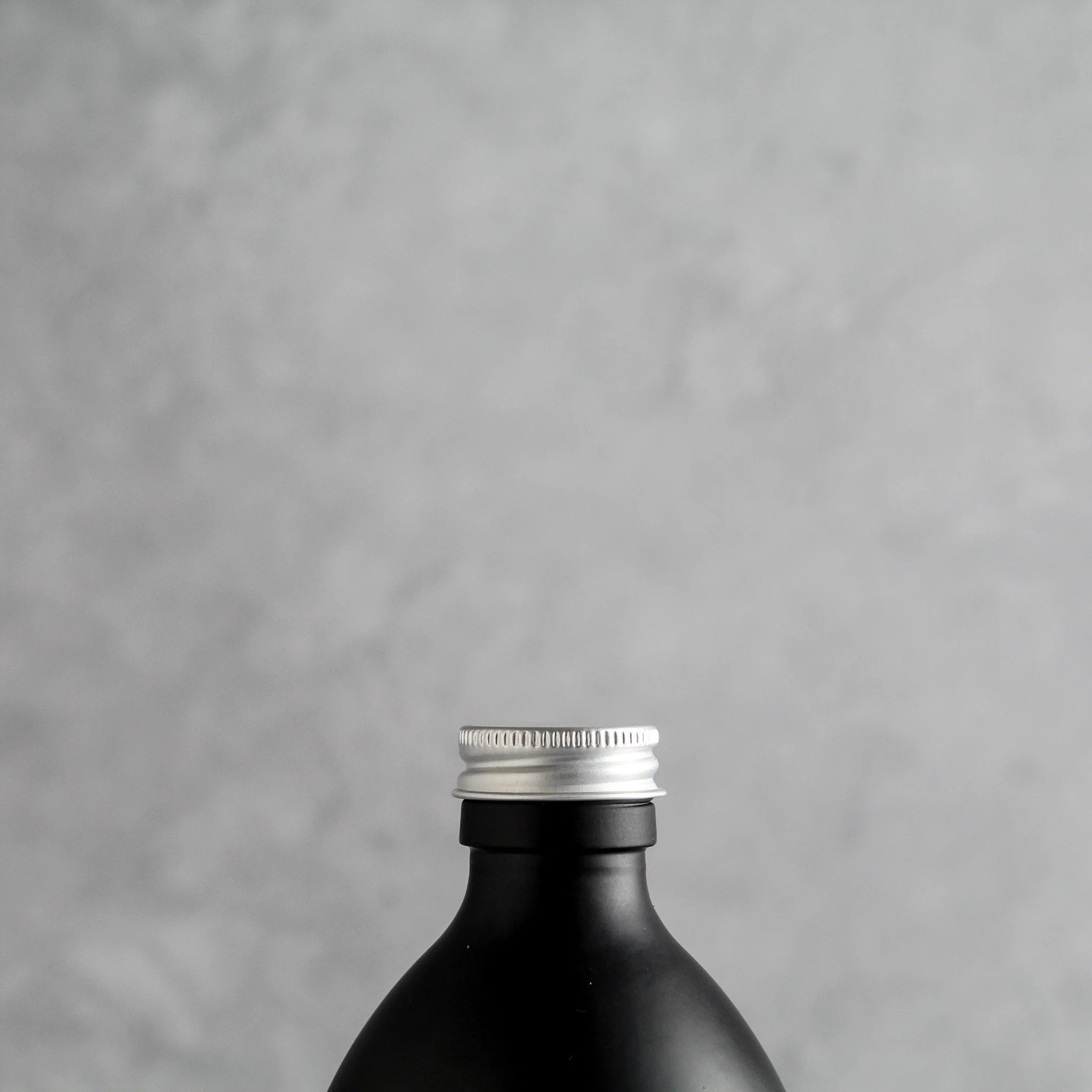 Labelled Matte Black Glass Bottle With Screw Cap - Image 4
